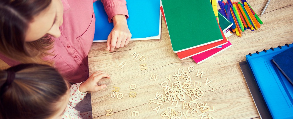 une femme aidant un enfant dans son apprentissage montessori